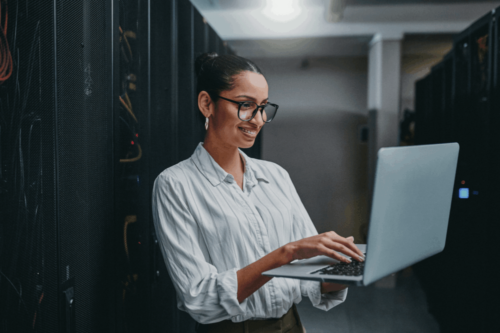 Woman standing whilst working on laptop
