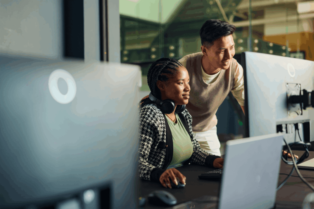 Two colleagues overlooking computer