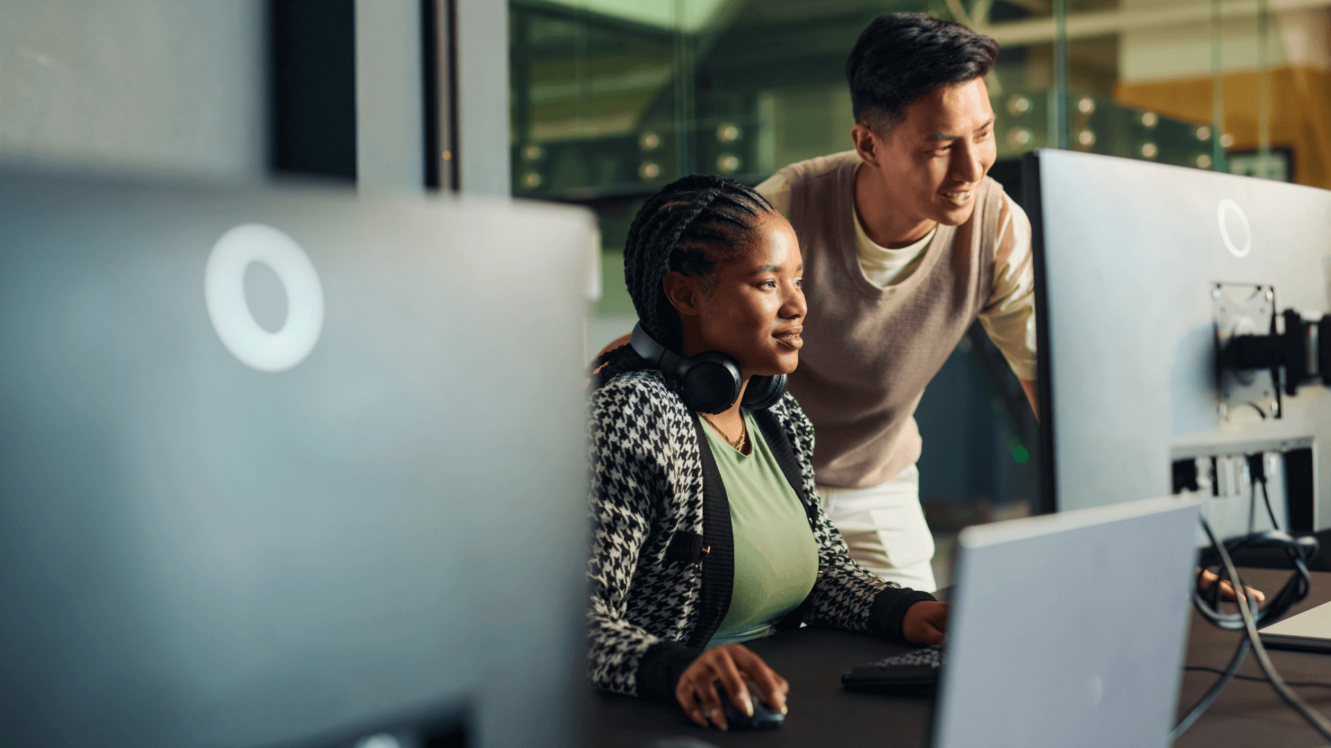 Two colleagues overlooking computer